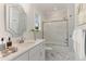 Clean bathroom with a shower/tub combo, white cabinets, and marble flooring at 613 Darian Woods, Holly Springs, NC 27540