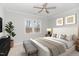 Cozy bedroom with a large bed, plenty of natural light, and a bench at the foot of the bed at 613 Darian Woods, Holly Springs, NC 27540
