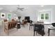 Versatile bonus room with seating area, game table, and ample natural light at 613 Darian Woods, Holly Springs, NC 27540