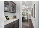 Butlers pantry with quartz countertops and glass-front cabinets at 613 Darian Woods, Holly Springs, NC 27540