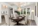 Elegant dining room with chandelier and large windows at 613 Darian Woods, Holly Springs, NC 27540