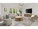 Spacious Gathering room with comfortable seating, large windows, and a flat-screen TV at 613 Darian Woods, Holly Springs, NC 27540