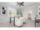 Bright home office features a glass desk, comfortable seating, and built-in shelving at 613 Darian Woods, Holly Springs, NC 27540