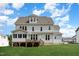 Two-story home with gray siding, deck, and screened porch at 613 Darian Woods, Holly Springs, NC 27540