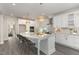 Modern kitchen with white cabinets, marble countertops, and large island at 613 Darian Woods, Holly Springs, NC 27540