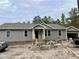 New home exterior with gray siding and a small porch at 6640 Sheriff Watson Rd, Sanford, NC 27332