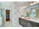 Elegant bathroom with double vanity and patterned wallpaper at 9516 Woodriver Dr, Zebulon, NC 27597