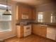 Bright kitchen featuring light wood cabinets, hardwood floors and stainless steel appliances at 106 S Fields Cir, Chapel Hill, NC 27516