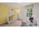 Bright Bedroom with crib, rocking chair, and ample natural light at 110 Tobacco Woods Dr, Youngsville, NC 27596