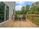 Wooden deck with two adirondack chairs and a view of the backyard at 110 Tobacco Woods Dr, Youngsville, NC 27596