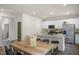 Dining area with kitchen view, hardwood floors, and access to a deck at 110 Tobacco Woods Dr, Youngsville, NC 27596