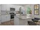 Modern kitchen with white cabinets, granite countertops, and stainless steel appliances at 110 Tobacco Woods Dr, Youngsville, NC 27596
