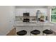 Modern kitchen with white cabinets, granite island, and stainless steel appliances at 110 Tobacco Woods Dr, Youngsville, NC 27596