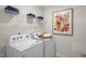 Laundry room with washer, dryer, and shelving at 110 Tobacco Woods Dr, Youngsville, NC 27596