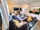 Bright and airy living room with sectional sofa and large windows at 110 Tobacco Woods Dr, Youngsville, NC 27596