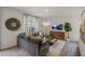 Living room features sectional sofa, large TV, and wood flooring at 110 Tobacco Woods Dr, Youngsville, NC 27596