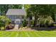 Two-story house with gray siding, manicured lawn, and mature trees at 1816 Hunting Ridge Rd, Raleigh, NC 27615