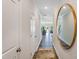 Bright hallway with hardwood floors and a large, circular mirror at 3007 Vitner Dr, Durham, NC 27704