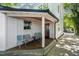 Side porch with modern seating and access to driveway at 404 W Roanoke Park Dr, Raleigh, NC 27608