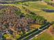 Aerial view showing property, neighboring houses, and surrounding landscape at 505 Lucian Hilliard Rd, Goldston, NC 27252