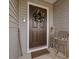 Brown front door decorated with a festive holiday wreath at 505 Lucian Hilliard Rd, Goldston, NC 27252