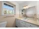 Clean bathroom with single sink vanity, mirror, and shower/tub combo at 5813 Cheek Rd, Durham, NC 27704