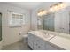 Bathroom with single sink vanity, shower and tile flooring at 5813 Cheek Rd, Durham, NC 27704