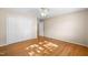 Bedroom with hardwood floors, double door closet and ceiling fan at 5813 Cheek Rd, Durham, NC 27704