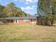 Brick ranch house with covered porch and large yard at 5813 Cheek Rd, Durham, NC 27704
