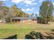 Brick ranch house with covered porch and large yard at 5813 Cheek Rd, Durham, NC 27704