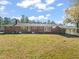 Rear view of brick ranch house, spacious backyard at 5813 Cheek Rd, Durham, NC 27704
