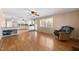 Bright living room with hardwood floors, fireplace, and ceiling fan at 5813 Cheek Rd, Durham, NC 27704