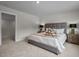 Main bedroom with gray upholstered bed, nightstands, and access to a closet at 626 Brittany Ct, Durham, NC 27703