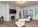 Bright living room featuring a fireplace, hardwood floors, and ample natural light at 1018 Quiver Ln, Durham, NC 27703