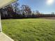 Open grassy backyard with mature trees and a sunny view at 198 Pate Landing Dr, Selma, NC 27576