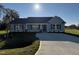 Gray house with a concrete driveway and landscaping at 198 Pate Landing Dr, Selma, NC 27576