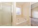 Bathroom with bathtub, shower, and a window at 2124 Star Sapphire Dr, Raleigh, NC 27610