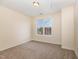 Simple bedroom with carpeted floor and a large window at 2124 Star Sapphire Dr, Raleigh, NC 27610