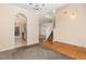Open living and dining area with hardwood and carpet flooring, and stairs to the second floor at 2124 Star Sapphire Dr, Raleigh, NC 27610