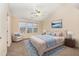 Spacious main bedroom with carpeted floor, a ceiling fan and large windows at 2124 Star Sapphire Dr, Raleigh, NC 27610