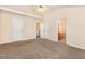 Main bedroom with carpet, ceiling fan, and doors to closets and bathroom at 2124 Star Sapphire Dr, Raleigh, NC 27610