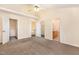 Main bedroom with carpet, ceiling fan, and doors to closets and bathroom at 2124 Star Sapphire Dr, Raleigh, NC 27610