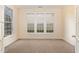 Bright home office with three large windows and neutral-toned carpet at 2124 Star Sapphire Dr, Raleigh, NC 27610