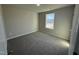 Well-lit bedroom with neutral carpeting and a large window providing natural light at 29 Pate Landing Dr, Selma, NC 27576