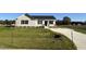 New construction home features a beige exterior, neat landscaping, and a spacious driveway at 29 Pate Landing Dr, Selma, NC 27576
