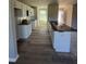 Open kitchen boasts granite countertops, white cabinetry, and a breakfast bar at 29 Pate Landing Dr, Selma, NC 27576