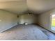 Open living area featuring vaulted ceilings, a ceiling fan, and a door leading outside at 29 Pate Landing Dr, Selma, NC 27576