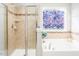 Bathroom with shower, garden tub, and window at 3911 Massey Wood Trl, Raleigh, NC 27616