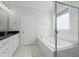 Elegant bathroom with soaking tub, walk-in shower, and stylish tile floor at 407 Eagle Ct, Henderson, NC 27536