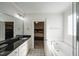 Main bathroom with soaking tub and walk-in shower at 407 Eagle Ct, Henderson, NC 27536